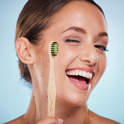 Buy stock photo Brushing teeth, dental and woman with toothbrush, wink and beauty, oral health and fresh breath with studio background. Mouth wellness, Invisalign portrait and teeth whitening with bamboo brush.