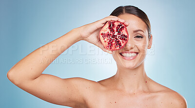 Buy stock photo Face portrait, skincare and woman with pomegranate in studio on a blue background. Organic cosmetics, beauty and female model with product, fruit or food for vitamin c, nutrition and healthy diet.