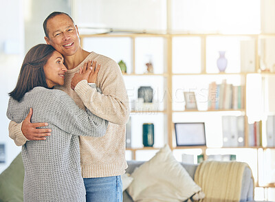 Buy stock photo Love, romance and married with a couple hugging while standing in their home together with mockup or flare. Affection, bonding and hug with a mature man and woman embracing in their domestic house