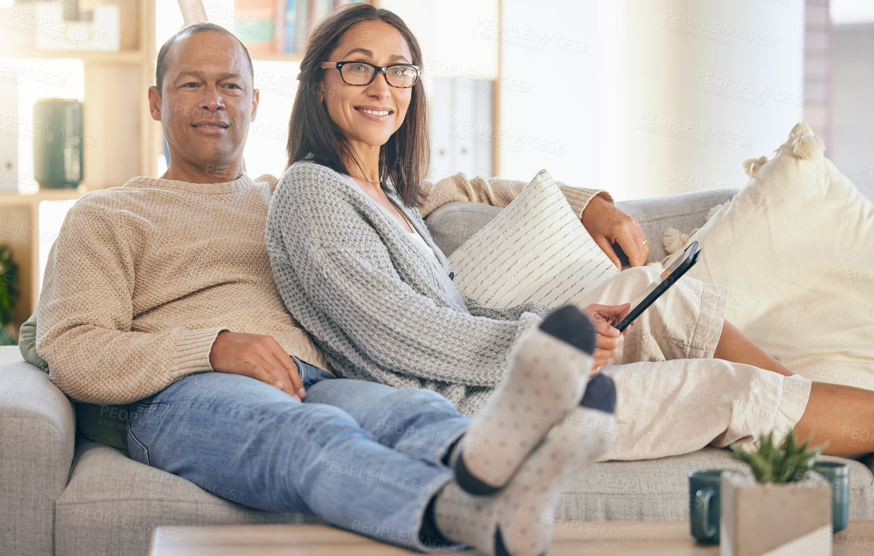 Buy stock photo Mature couple, tablet and relax portrait on sofa together for love, support and romance bonding in living room at home. Man smile, happy woman, and romantic quality time on couch with tech device