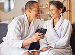 Senior couple, spa and relax happy with phone on sofa, wellness center and luxury body care or streaming video online. Happiness, woman and man smile together, smartphone and beauty therapy gown