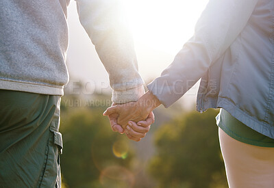 Buy stock photo Couple, holding hands with lens flare and outdoor in nature, love and bond with relationship and commitment with travel and adventure. Man, woman and hand holding, trust and support in the park.