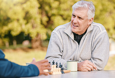 Buy stock photo Chess, nature and retirement with senior friends playing a boardgame while bonding outdoor during summer. Park, strategy and game with a mature man and friend thinking about the mental challenge