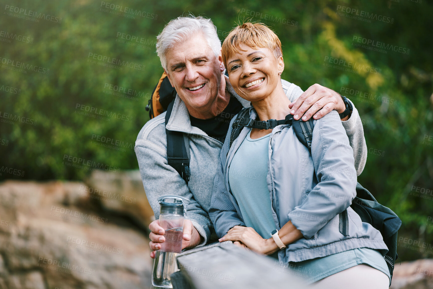 Buy stock photo Nature, hiking and portrait of a senior couple relaxing while walking in a forest for exercise. Love, happy and elderly people with a smile sitting to rest while trekking together in the woods.