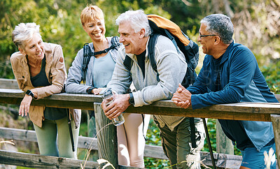 Buy stock photo Elderly, people hiking and happy in park with fitness outdoor, relax on bridge while trekking in nature together. Health, wellness and hiker group, sport and active lifestyle motivation with cardio.