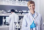 Science, thumbs up and research, woman pharmacist or healthcare scientist in medicine laboratory. Medical innovation, analytics and success, portrait of happy woman pharmaceutical employee with smile