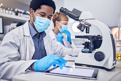 Buy stock photo Science, covid and black man in laboratory with microscope and face mask, search and motivation in vaccine development. Healthcare, scientist man or pharmacist with innovation in lab research.