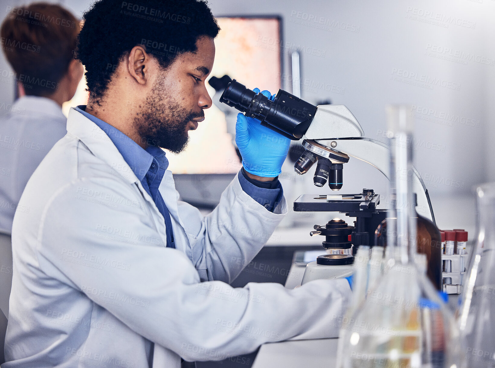 Buy stock photo Black man, scientist and microscope with science research in laboratory, data analysis and expert with scientific or medical innovation. Phd doctor, biotechnology with chemistry and study in lab.