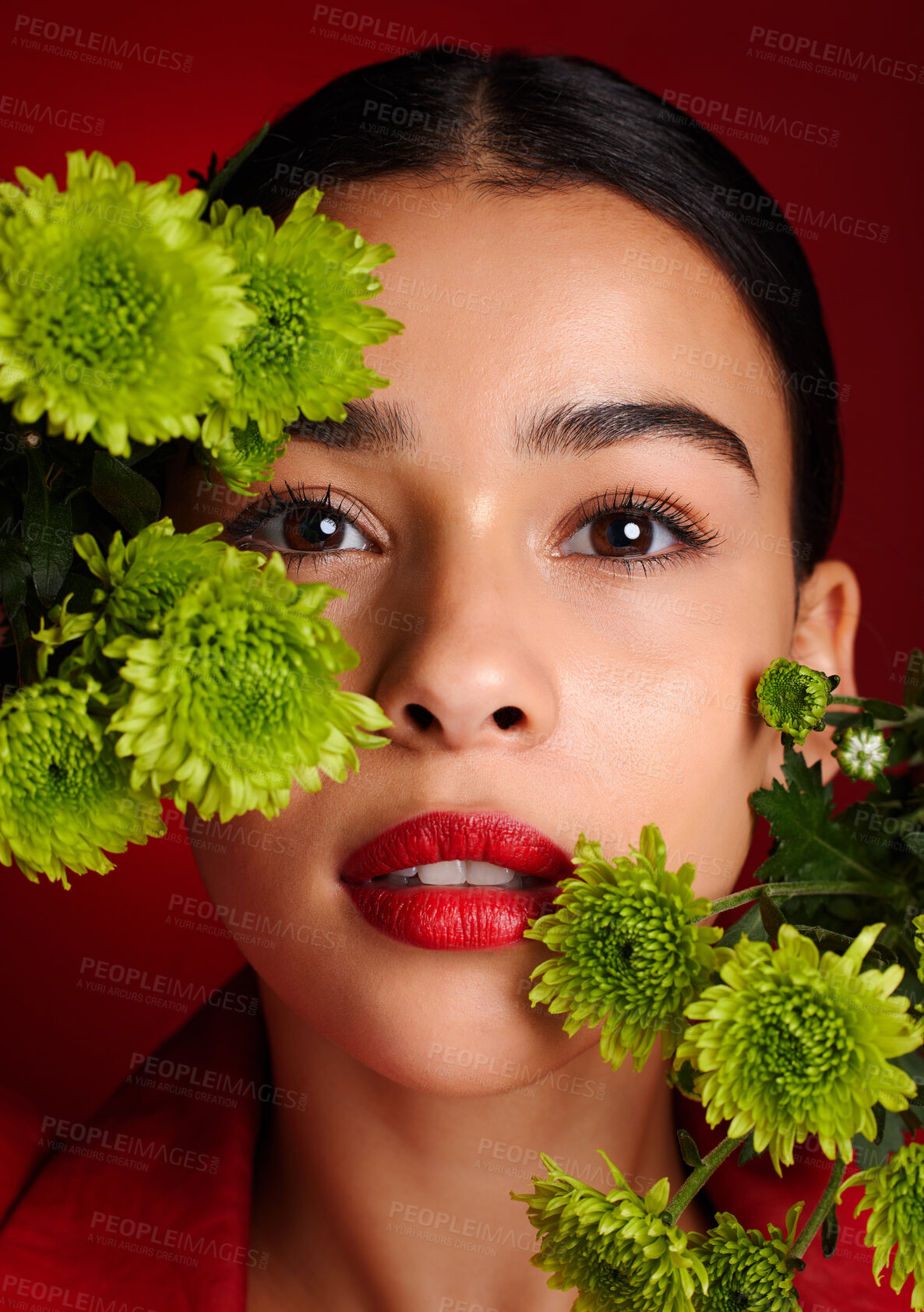 Buy stock photo Beauty, flowers and face with woman and lipstick, natural cosmetics with nature, skincare and organic treatment against red studio background. Lips, portrait and microblading, eyebrow care and makeup
