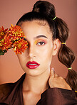 Makeup, beauty or woman in studio with flowers for art fashion and natural facial cosmetics for self care. Face portrait, orange plants or girl model with red lipstick, eyeshadow and glowing skin 