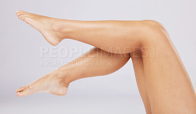 Buy stock photo Skincare, legs and woman with cosmetics, wellness and clear skin against grey studio background. Leg, feet and female with smooth treatment, glow or shine with grooming, natural beauty or luxury care