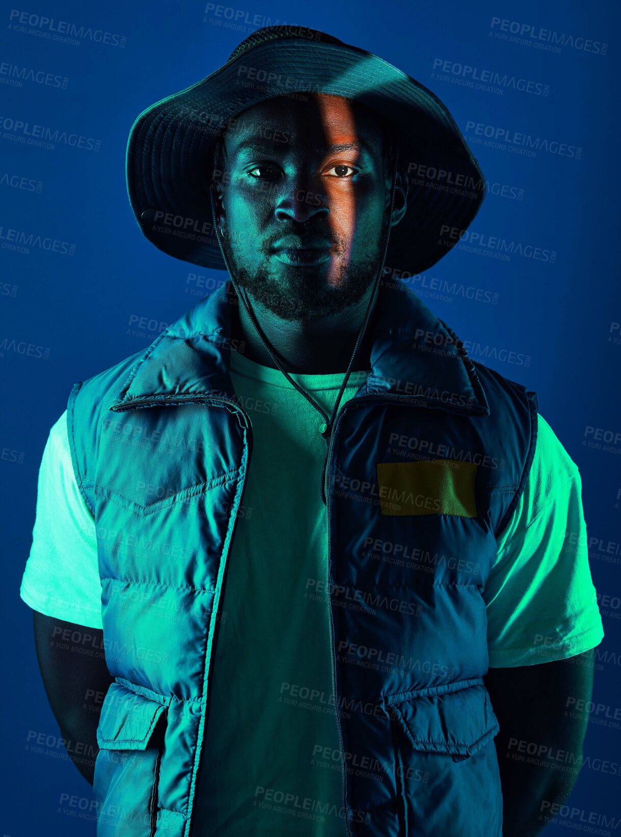 Buy stock photo Trendy, casual and portrait of a black man in a studio with a cool, stylish and edgy outfit. Fashion, style and African male model with modern clothes posing while isolated by a blue background.