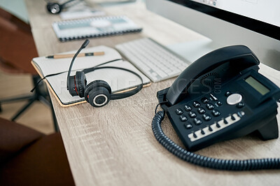 Buy stock photo Telemarketing office, phone and VOIP on desk for communication, contact us and consulting by computer. Modern office, telephone and headphones on table for customer support, help or service with pc