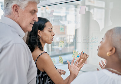 Buy stock photo Innovation, meeting or woman writing on a sticky note planning a startup project on glass board in office building. Focus, leadership or creative business people working on strategy ideas or solution