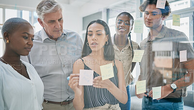 Buy stock photo Innovation, meeting or woman writing on a sticky note planning a startup project on glass board in office building. Focus, leadership or creative business people working on strategy ideas or solution