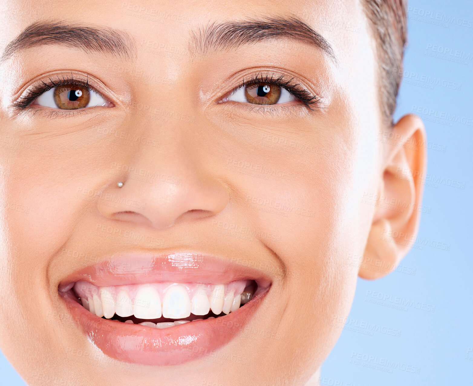 Buy stock photo Teeth, dental and face portrait of woman with clean smile, teeth whitening and oral self care on blue background. Tooth implant, healthcare and beauty model with makeup, cosmetics and facial skincare
