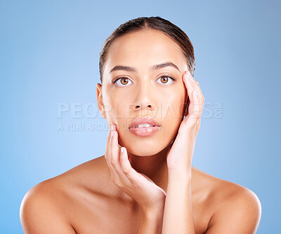 Buy stock photo Face portrait, skincare and beauty of woman in studio on a blue background. Hands, natural cosmetics and makeup of young female model with healthy, smooth and glowing skin after facial treatment.