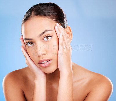 Buy stock photo Portrait, skincare or model in studio after beauty or facial grooming routine on a blue background with mockup space. Luxury, healthy girl or beautiful woman touching face for self love or self care
