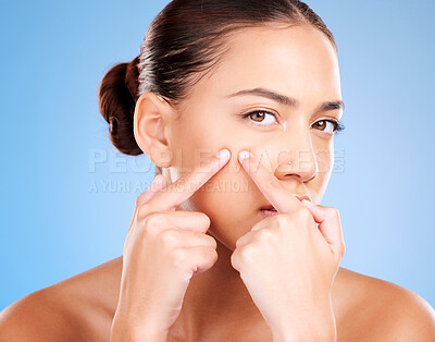 Buy stock photo Woman, face and squeeze pimples, acne and facial scar on studio blue background. Portrait of young female model worried for skincare problem, aesthetic beauty cosmetics and pop blackhead with fingers