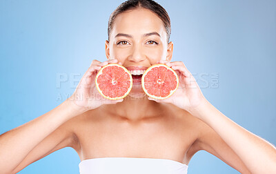 Buy stock photo Woman, studio portrait and grapefruit for skincare, natural cosmetic or health by blue background. Model, fruit and smile for nutrition, vitamin c or self care beauty for aesthetic by studio backdrop
