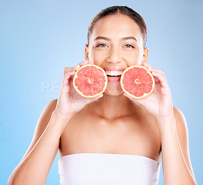 Buy stock photo Skincare, beauty and portrait of a woman with grapefruit for a natural, organic and healthy face routine. Cosmetic, wellness and girl model from Mexico with a tropical citrus fruit by blue background