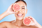 Beauty, grapefruit and woman with face and natural cosmetic care, facial and glow with vegan product against studio background. Skincare, healthy skin and wellness with fruit, hands and cosmetics.