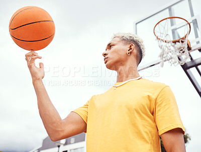 Buy stock photo Sports, fitness and man spinning basketball on court outdoors before workout, exercise or practice. Basketball court, balance and young male player with ball on finger getting ready for training.