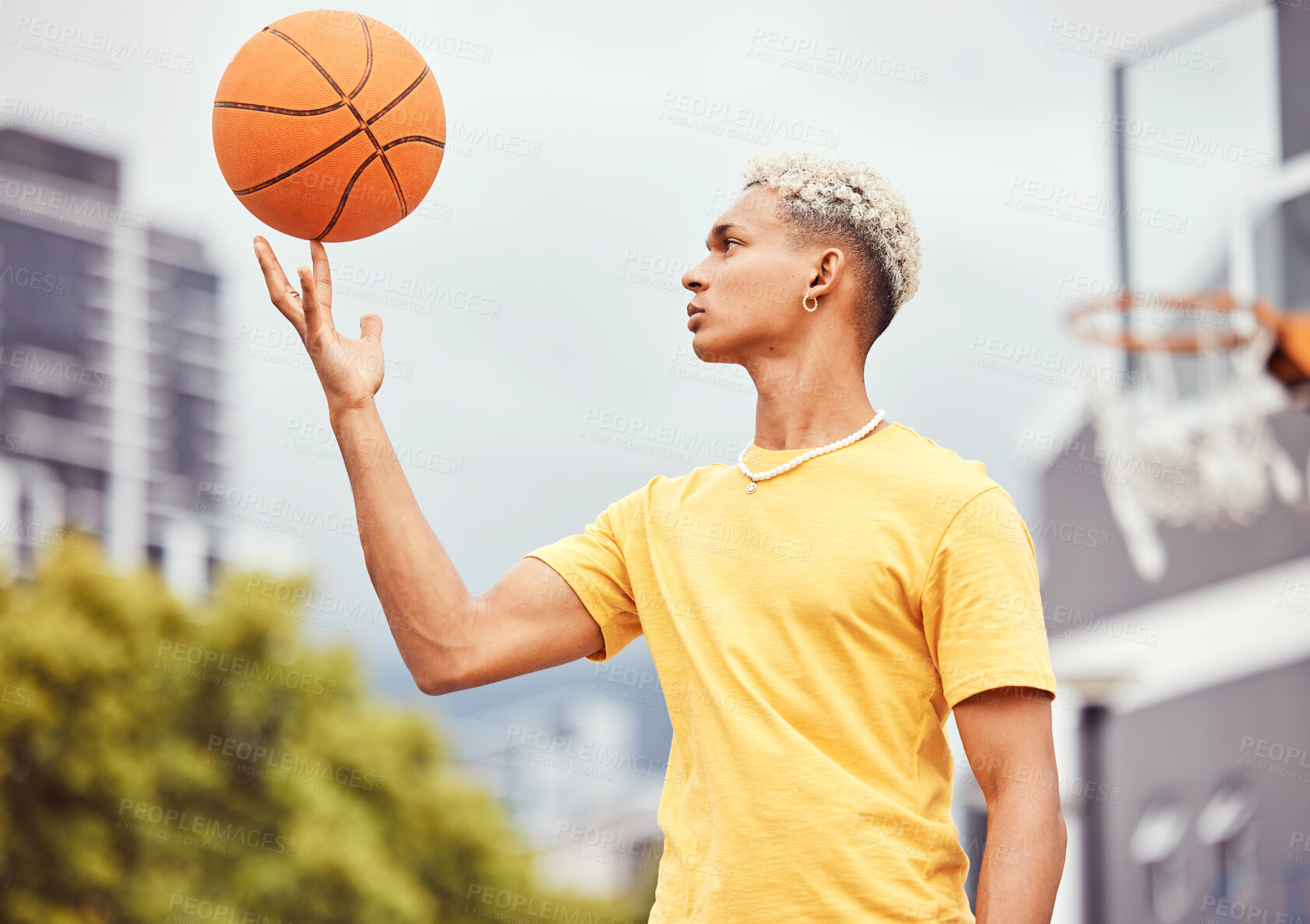 Buy stock photo Sports, fitness and man spinning basketball on court outdoors before workout, exercise or practice. Basketball court, balance and young male player with ball on finger getting ready for training.