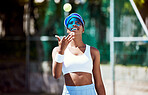 Tennis, black woman and athlete outdoor with sport on tennis court, happy with tennis ball and fitness. Exercise, sports motivation and wellness with workout and female tennis player smile