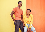 Black couple, smile and urban portrait by wall with edgy fashion, happy and bonding with color. Gen z, happy couple and city wall background with orange, yellow and love on adventure in Atlanta metro