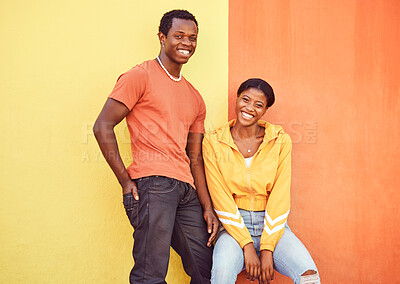 Buy stock photo Black couple, smile and urban portrait by wall with edgy fashion, happy and bonding with color. Gen z, happy couple and city wall background with orange, yellow and love on adventure in Atlanta metro
