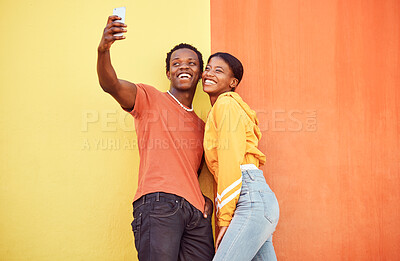 Buy stock photo Selfie, black couple and smile with gen z youth, smartphone and influencer with post for social media against color wall background. Happy in picture, fashion mockup and tech with young man and woman