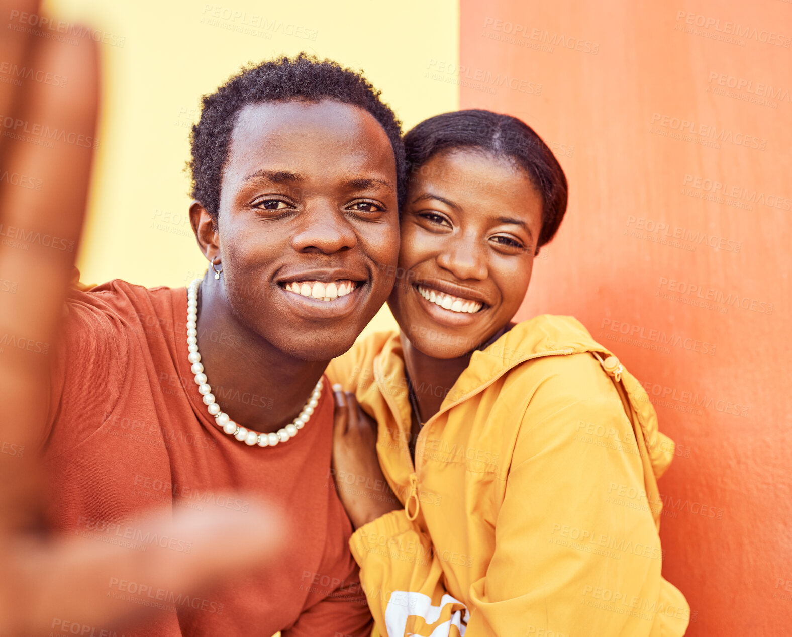 Buy stock photo Selfie, love and memories with a black couple posing for a photograph together on a color wall background. Portrait, happy and smile with a man and woman taking a picture while bonding outside