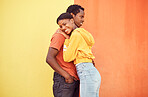 Couple, love or bonding hug by city wall background in trust, security or support in relax urban date, fun activity or holiday. Portrait, happy smile or black woman and man embrace on building mockup