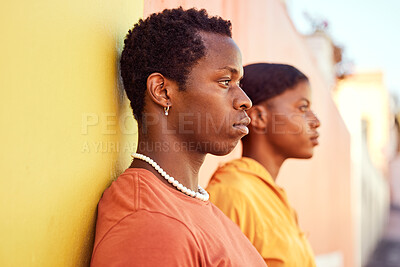 Buy stock photo Urban fashion, African people and couple of friends relax with designer brand clothes, casual style and luxury apparel. Gen z aesthetic, color and profile of black woman and man on orange yellow wall