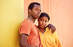 Fashion portrait of African couple, people or friends relax with designer brand clothes, casual style and luxury apparel. Urban gen z aesthetic, black woman and man on orange yellow background wall