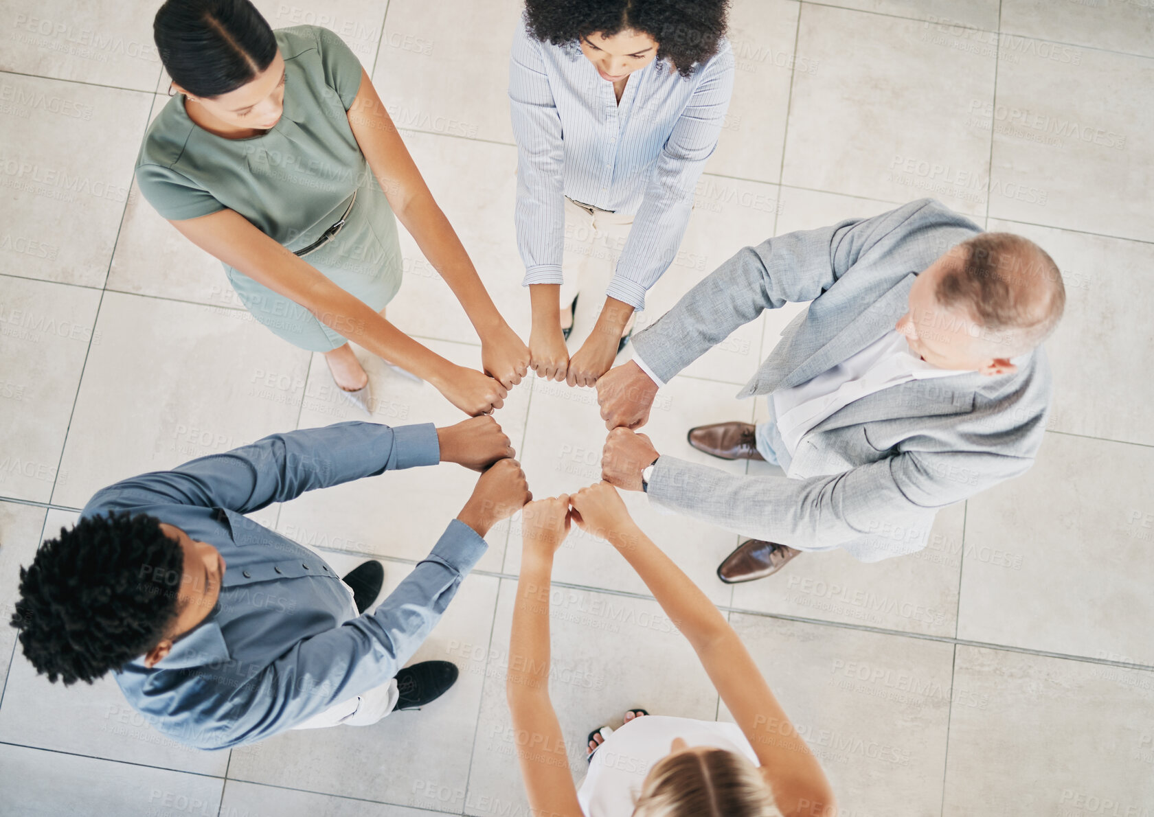 Buy stock photo Above, business people and fist bump circle in office for teamwork, motivation and support for success. Corporate group, vision and team building in workplace with diversity, solidarity and mission