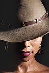 Woman, dark studio and hat for fashion, beauty and mystery with style, design or closeup headshot. Girl, model and black background for fantasy, night aesthetic or makeup for edgy, sexy woman and art