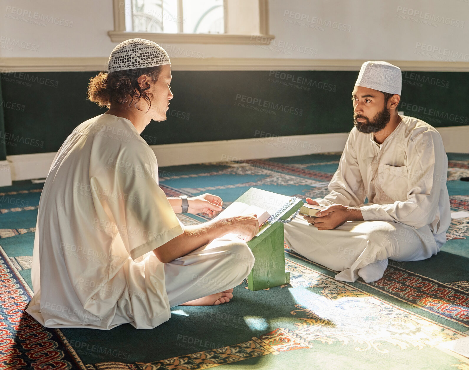 Buy stock photo Quran, muslim and mosque with an imam teaching a student about religion, tradition or culture during eid. Islam, book or worship with a religious teacher and islamic male praying together for ramadan