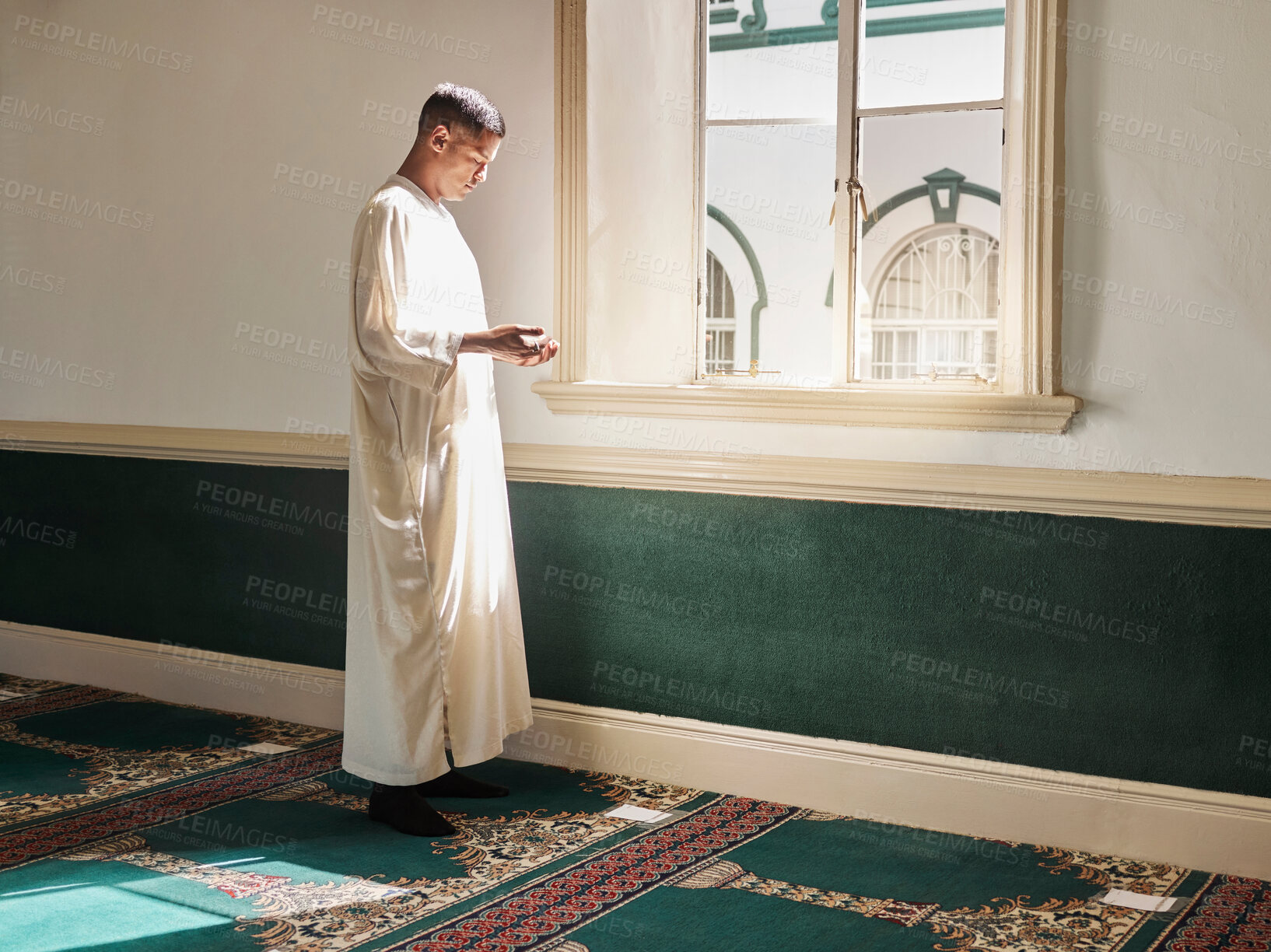 Buy stock photo Muslim, prayer or man in a mosque praying to Allah for spiritual mindfulness, support or wellness in Doha, Qatar. Religion, peace or Islamic person in temple to worship or praise God with gratitude