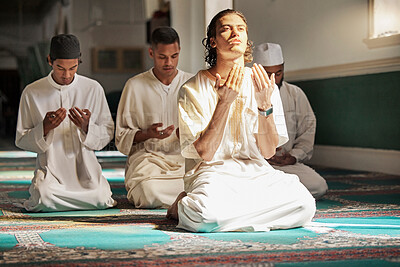 Buy stock photo Muslim, prayer and mosque with a spiritual young man holy group praying together in religion while devoted to God. Salah, worship and pray with islamic friends observing ramadan tradition or faith