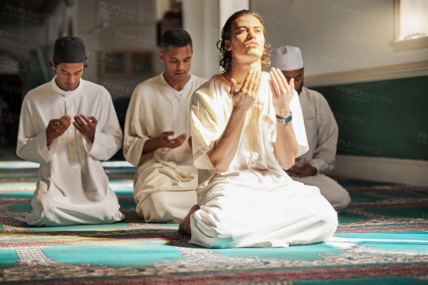 Buy stock photo Muslim, prayer and mosque with a spiritual young man holy group praying together in religion while devoted to God. Salah, worship and pray with islamic friends observing ramadan tradition or faith