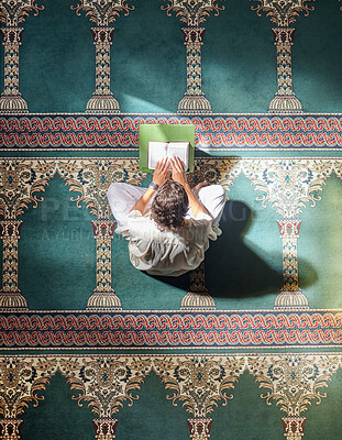 Buy stock photo Religion, quran and Muslim man reading for spiritual education, learning worship and faith during ramadan. Islam, holy and above of an Islamic person with a book in a mosque for studying prayer