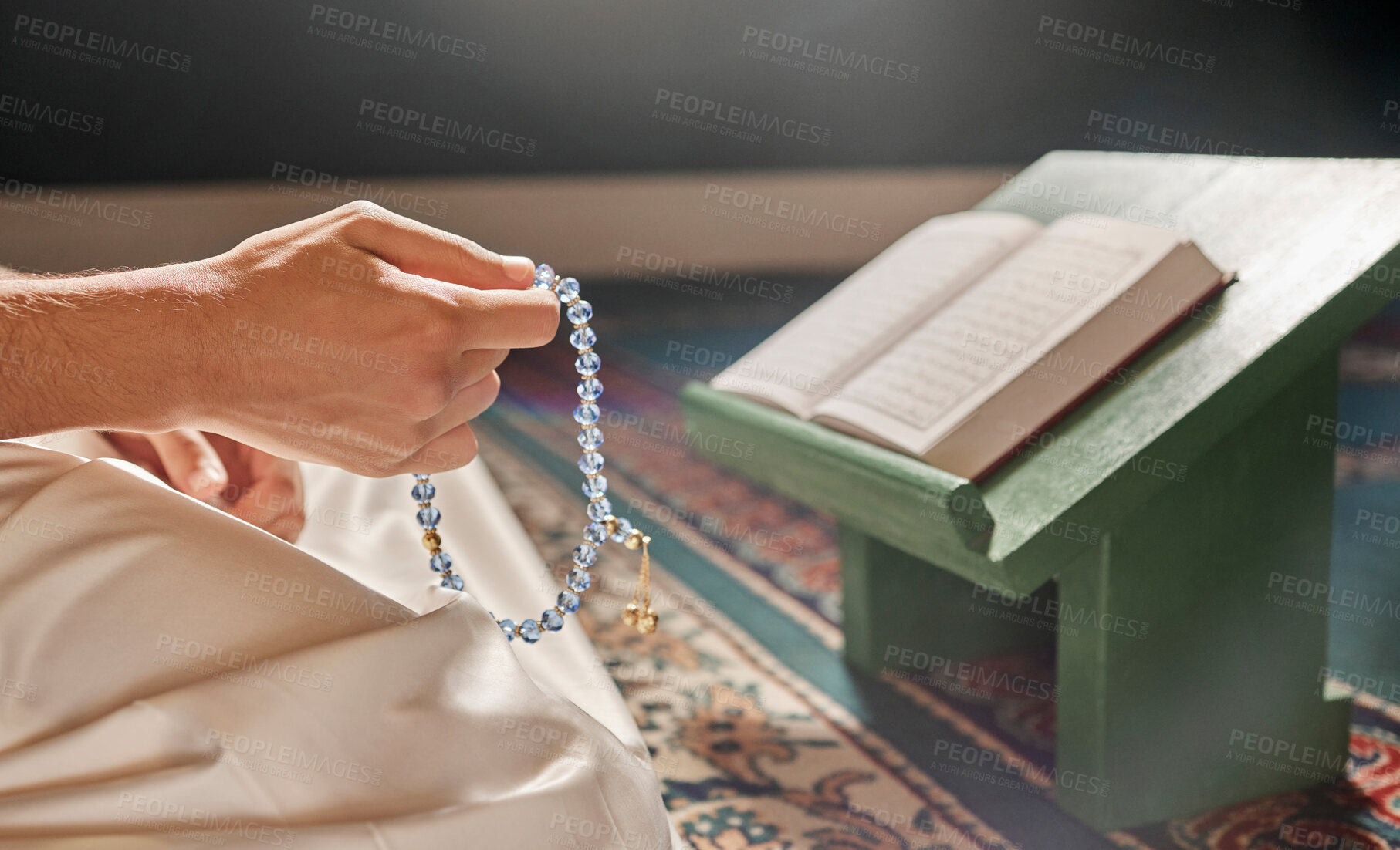 Buy stock photo Quran, beads or hands praying in Islamic or Muslim religion to Allah for spiritual peace or freedom in mosque in Qatar. Muslim pray, reading or person kneeling on carpet in holy temple to praise God