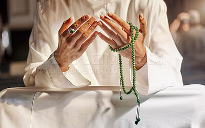 Buy stock photo Hands, prayer beads and muslim man praying in mosque, temple or church. Islam, worship and islamic male with beads for worshiping Allah, God or holy spirit for hope, spiritual faith and religion.