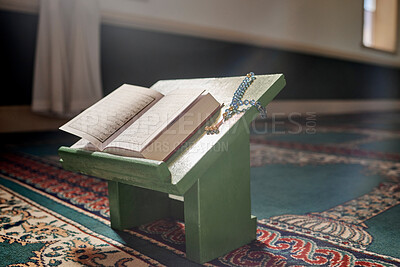 Buy stock photo Quran, prayer beads and mosque with an open book and a rosary in an empty holy room or temple ready for praying. Islamic misbaha, tasbih or sibha and scripture in a muslim place of worship for eid
