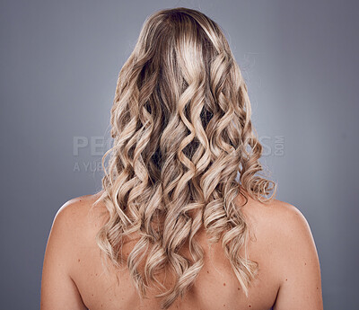 Buy stock photo Hair, beauty and style with a model woman in studio on a gray background to promote keratin treatment. Curly hairstyle, haircare and back with a female posing for natural care for strong roots