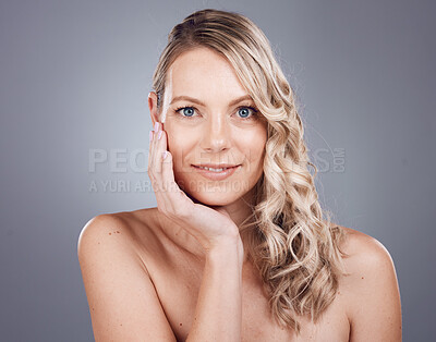 Buy stock photo Portrait, beauty and hair with a model woman in studio on a gray background for keratin treatment or natural haircare. Face, skincare and wellness with a female posing to promote a haircare product