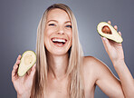 Portrait, beauty and avocado with a model woman in studio on a gray background for natural treatment. Face, skincare and nutrition with an attractive young female posing to promote skin antioxidants