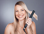 Woman, hair care portrait and flat iron with smile, beauty and happiness with self love by studio background. Model, hair and self care grooming with straightener for hairstyle aesthetic by backdrop